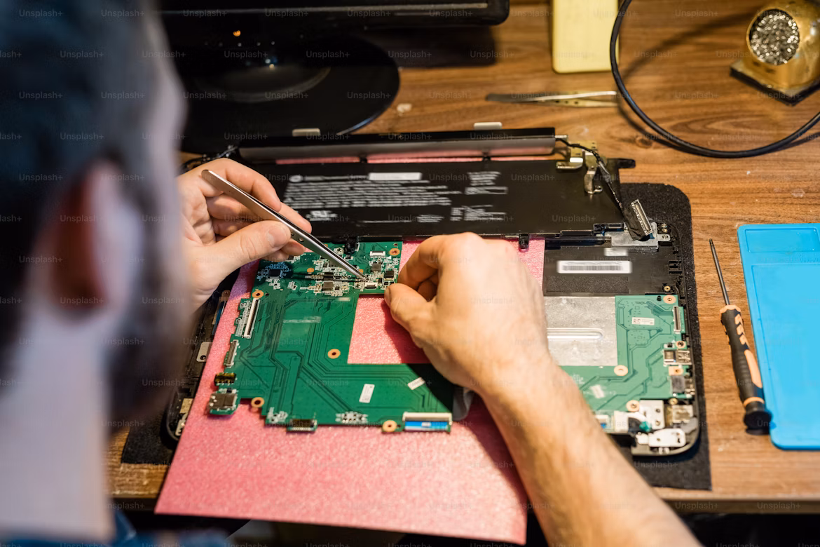 Technician repairing a laptop and computer in Agra